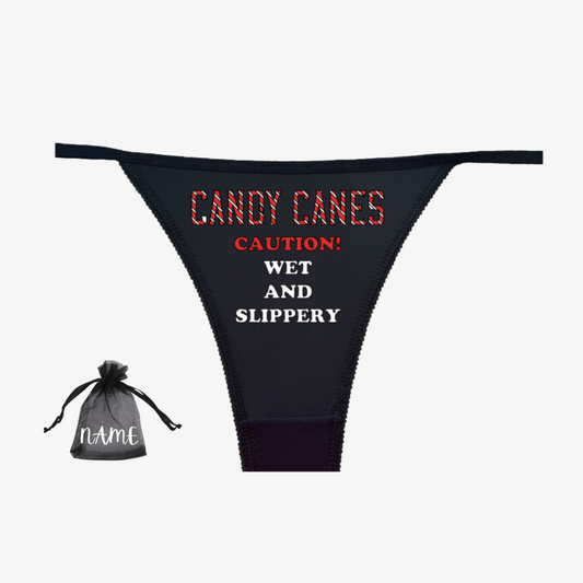 a black thong with candy canes on it next to a drawstring bag