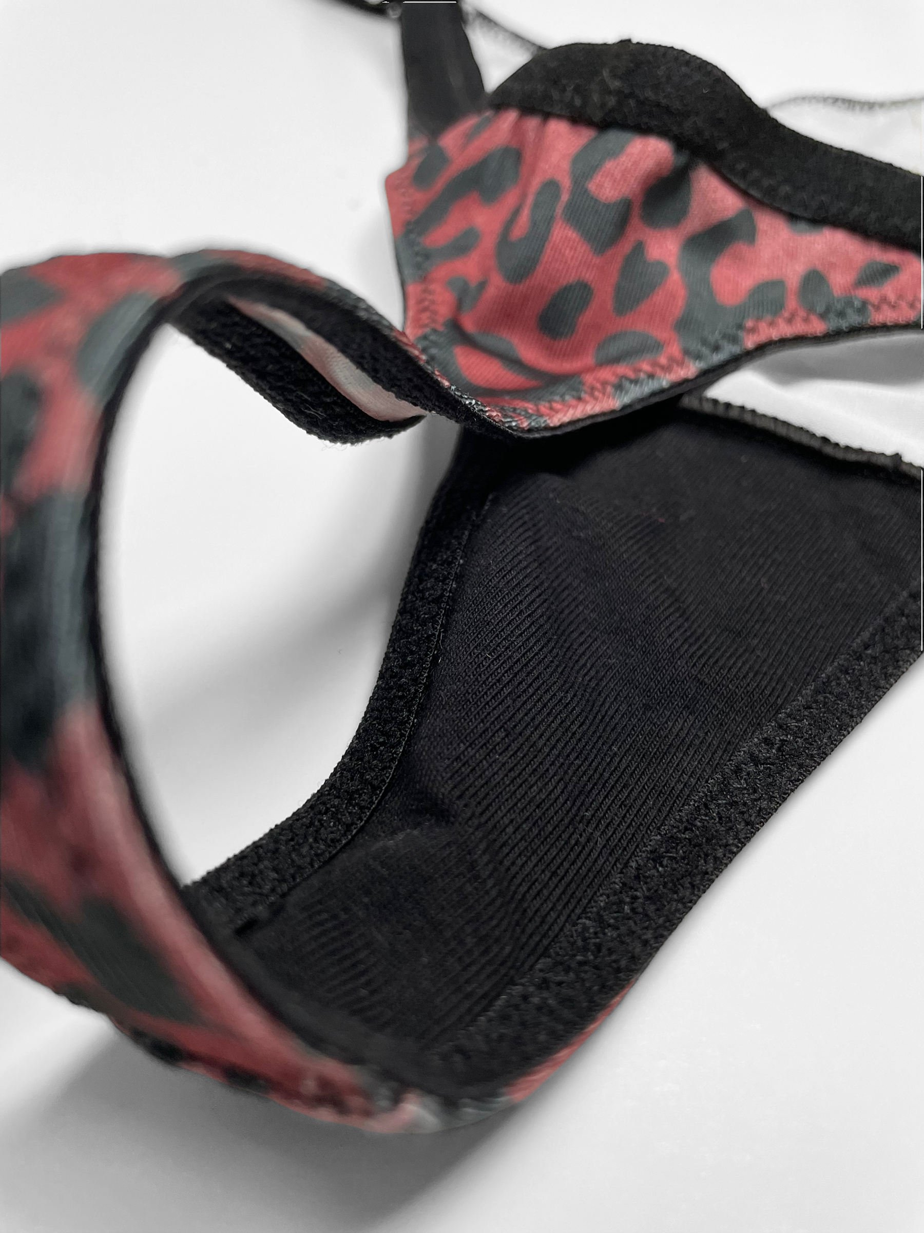 a red and black leopard print harness on a white background